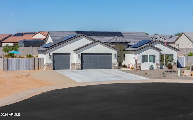 view of front of house with solar panels and a garage