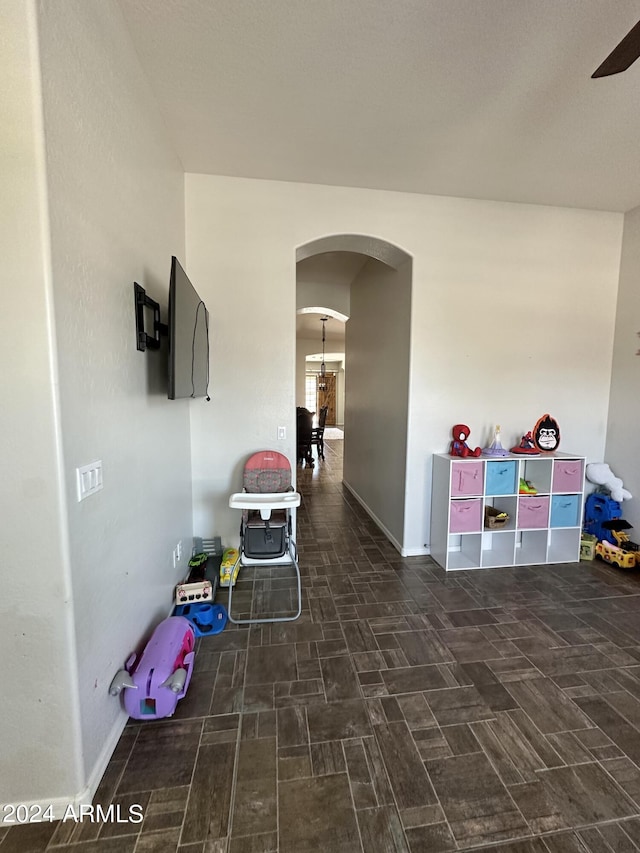 playroom with dark tile flooring