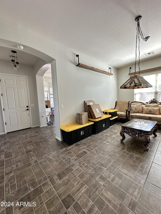 recreation room with dark tile floors and a textured ceiling