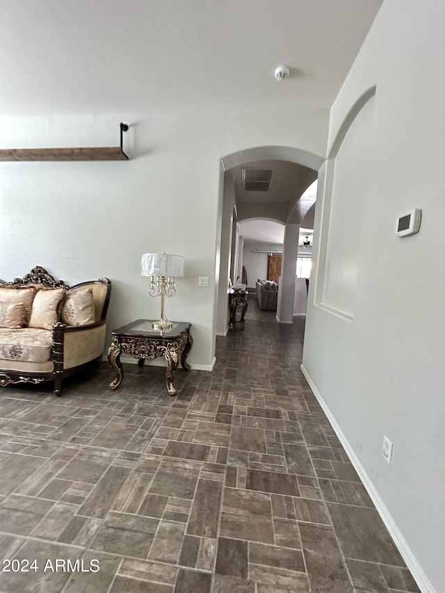 corridor featuring dark tile floors