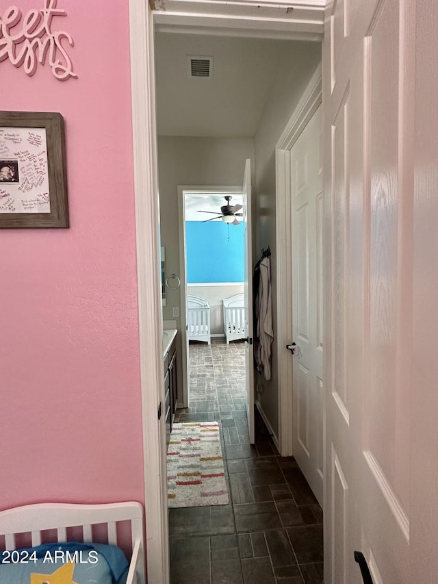 hallway with dark tile flooring