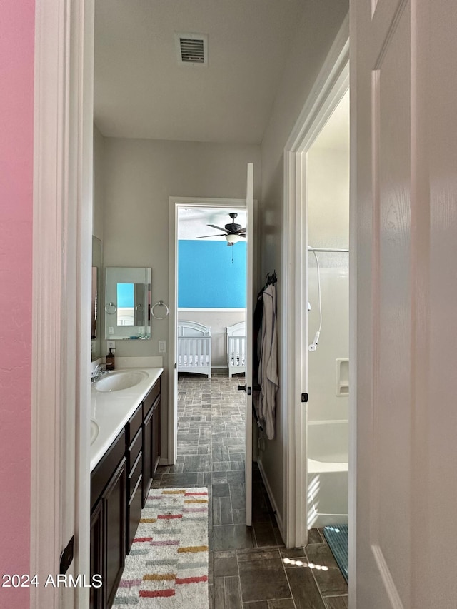 bathroom featuring oversized vanity, ceiling fan, and tile floors