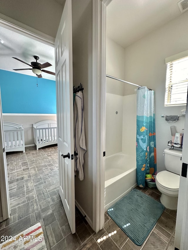 bathroom featuring tile flooring, ceiling fan, toilet, and shower / bath combo with shower curtain