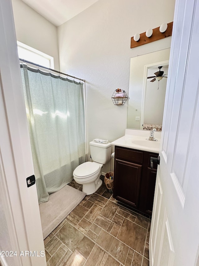 bathroom featuring ceiling fan, toilet, tile flooring, and vanity