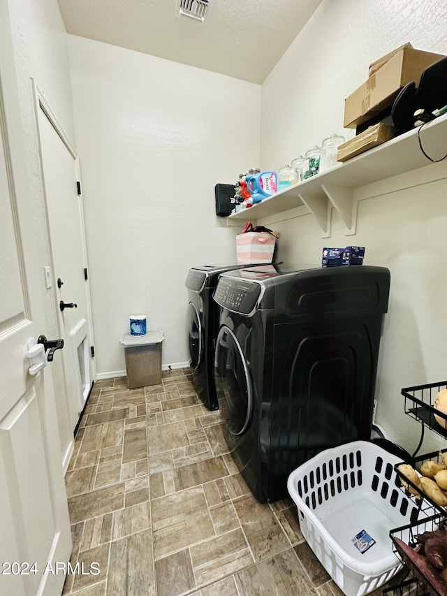 laundry area featuring tile flooring and washer and dryer