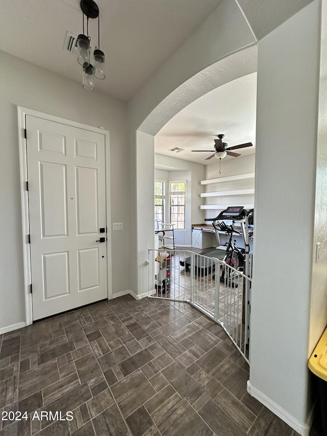 tiled entrance foyer with ceiling fan