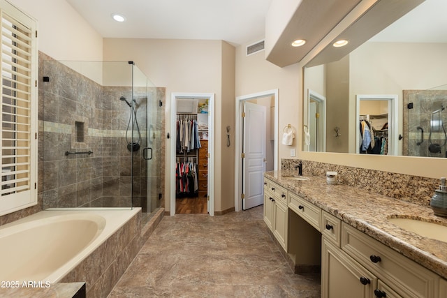 bathroom with vanity and separate shower and tub