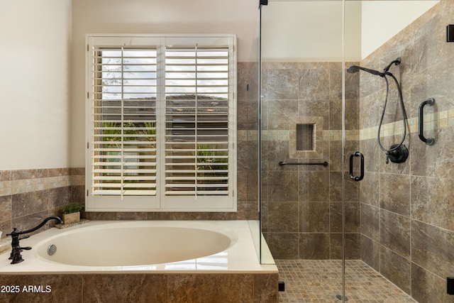 bathroom featuring independent shower and bath