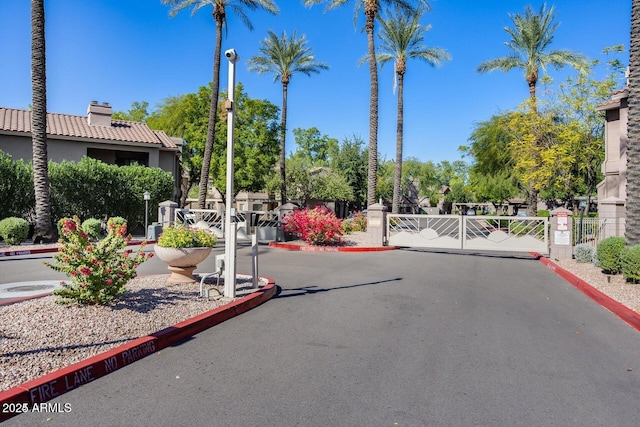15252 N 100th St Unit 1164, Scottsdale, AZ 85260 - view of asphalt street featuring a gate, curbs, and a gated entry