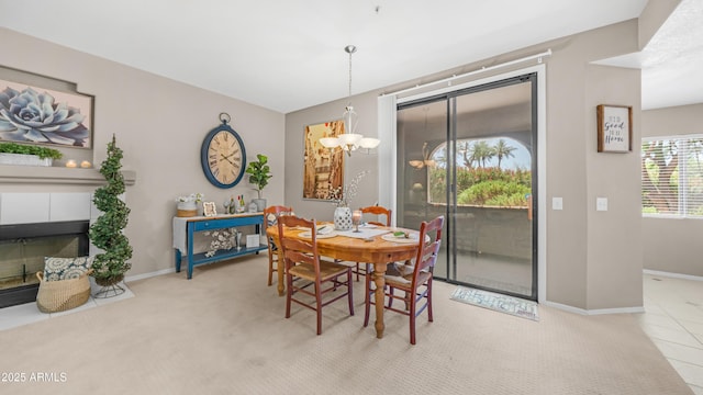 15252 N 100th St Unit 1164, Scottsdale, AZ 85260 - dining space featuring a tiled fireplace, a chandelier, and carpet flooring