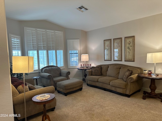 carpeted living room featuring vaulted ceiling