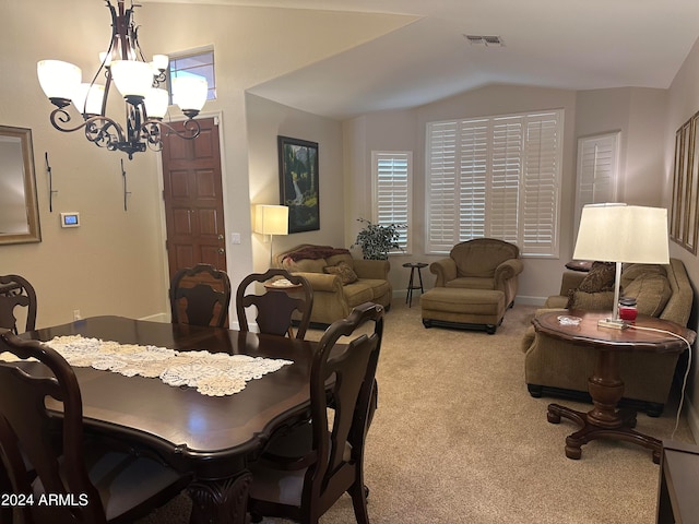 dining space featuring lofted ceiling, light colored carpet, and a notable chandelier