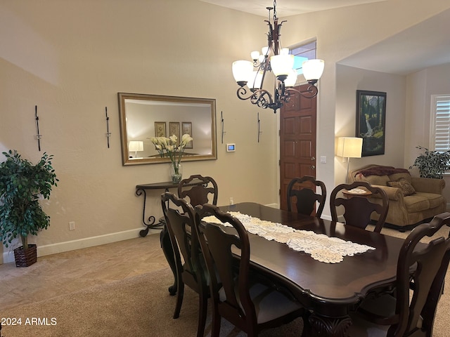 carpeted dining space with a chandelier