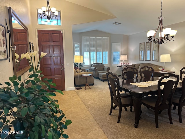 carpeted dining area with a notable chandelier and vaulted ceiling