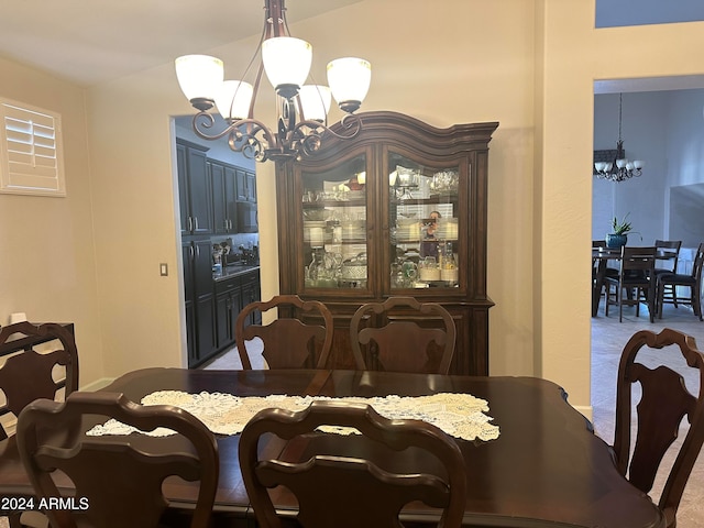 dining area with an inviting chandelier and carpet flooring