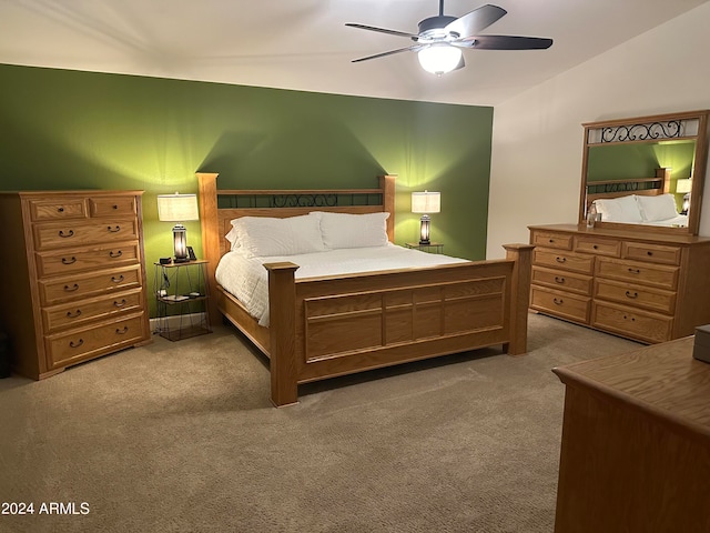 carpeted bedroom featuring vaulted ceiling and ceiling fan