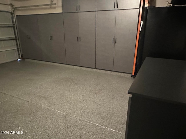 garage with black fridge