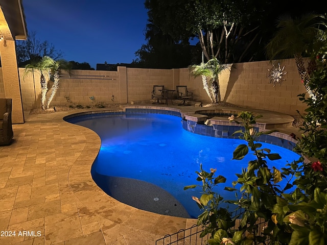 view of swimming pool featuring an in ground hot tub and a patio