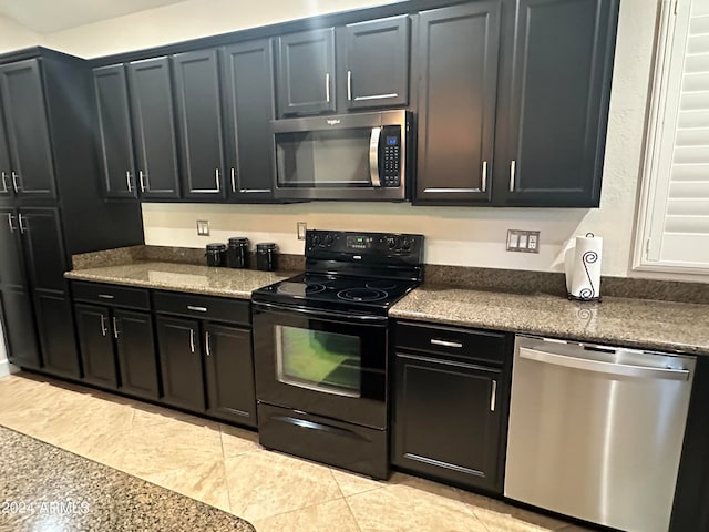 kitchen with light tile patterned floors and stainless steel appliances