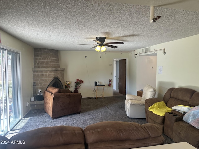 carpeted living room featuring a textured ceiling, a brick fireplace, and ceiling fan