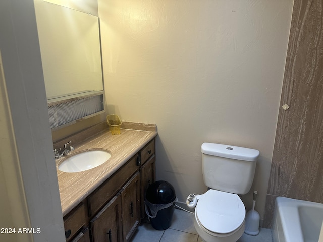 bathroom with toilet, vanity, tile patterned flooring, and a bath