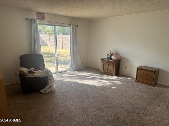 unfurnished room with dark carpet and a textured ceiling