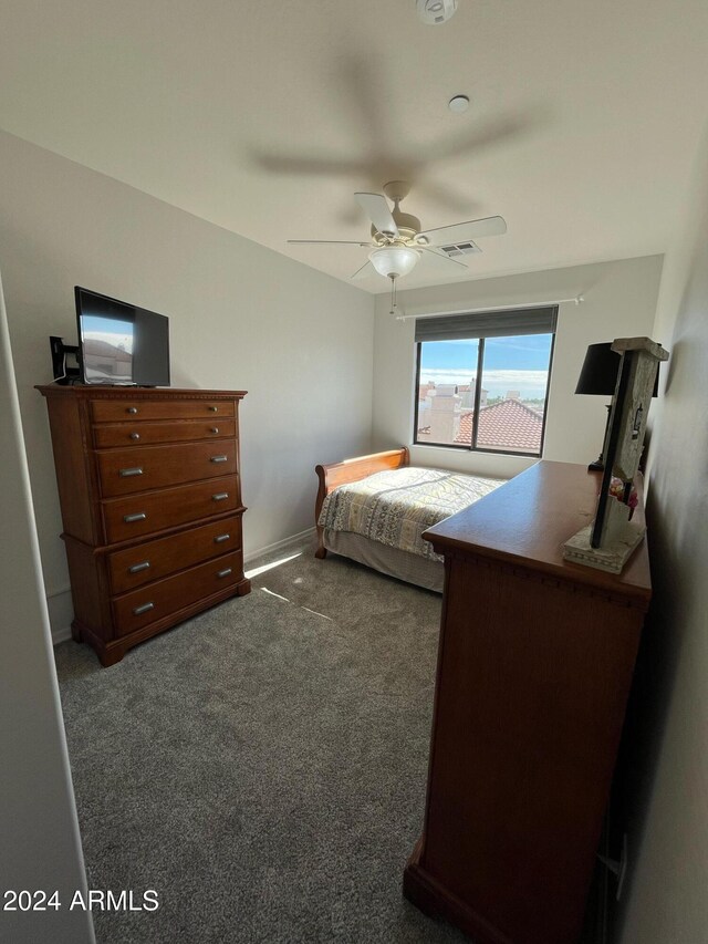 unfurnished bedroom with dark colored carpet and ceiling fan