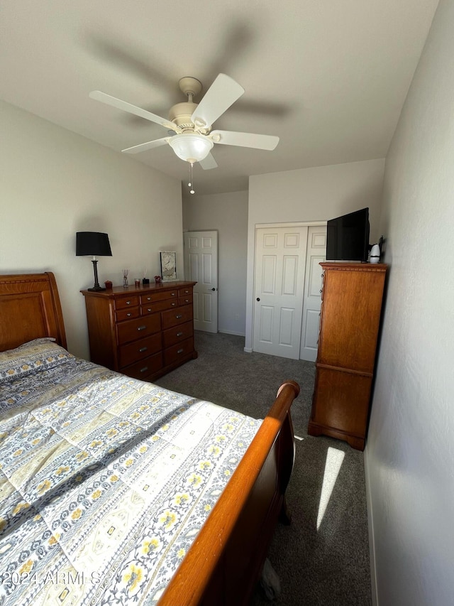 bedroom featuring dark colored carpet, ceiling fan, and a closet