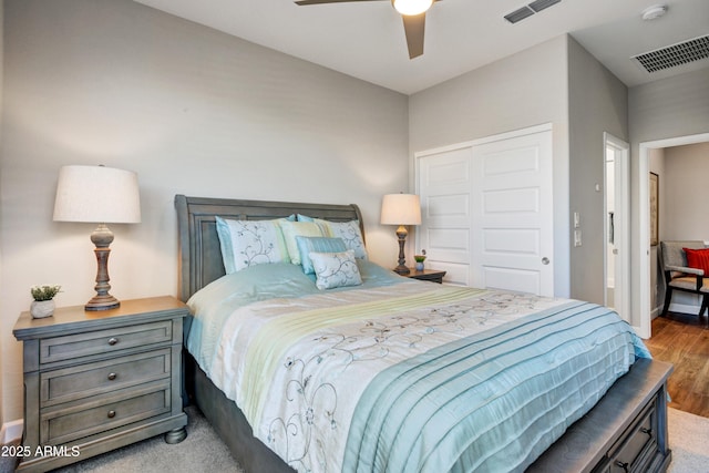 bedroom with wood finished floors, a closet, a ceiling fan, and baseboards