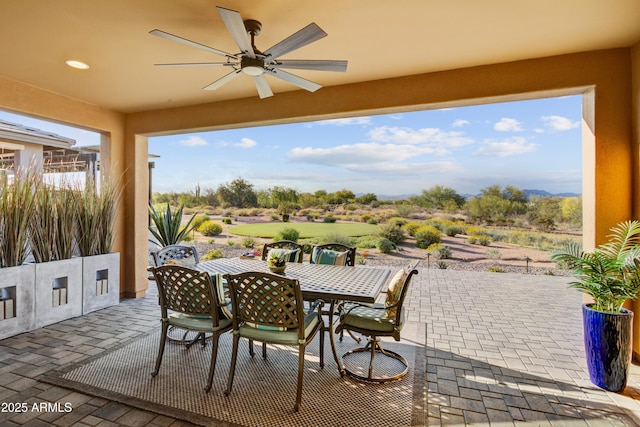 view of patio / terrace with ceiling fan and outdoor dining space