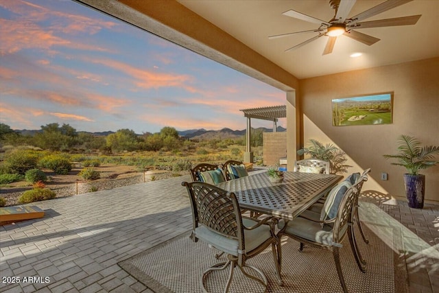 patio terrace at dusk with ceiling fan and outdoor dining area