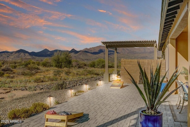 view of patio / terrace with a mountain view and a pergola