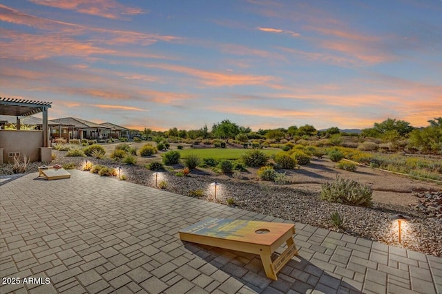 patio terrace at dusk with a pergola