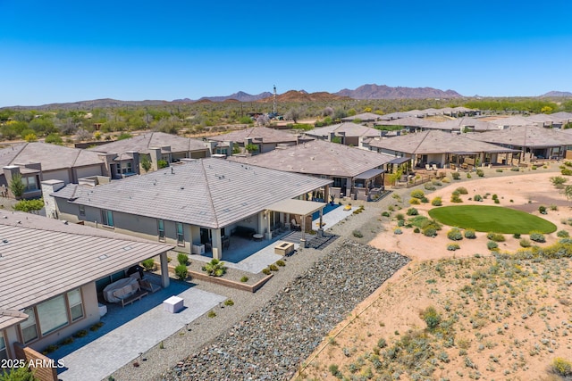 aerial view of residential area featuring a mountainous background