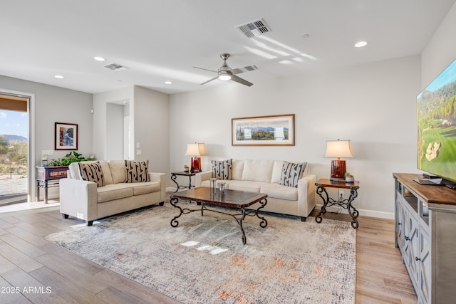 living area with light wood finished floors, recessed lighting, ceiling fan, and baseboards