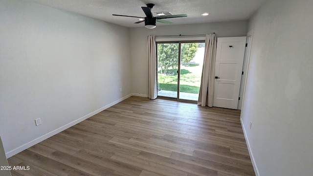 4442 E Aire Libre Ave, Phoenix, AZ 85032 - unfurnished room featuring ceiling fan, baseboards, wood finished floors, recessed lighting, and a textured ceiling