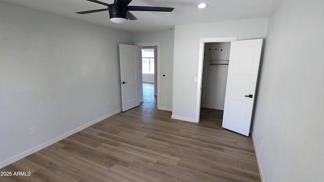 4442 E Aire Libre Ave, Phoenix, AZ 85032 - unfurnished bedroom featuring wood finished floors, baseboards, a walk in closet, ceiling fan, and recessed lighting