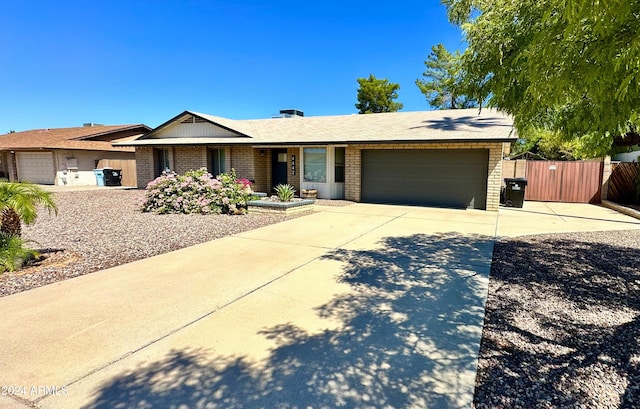 4442 E Aire Libre Ave, Phoenix, AZ 85032 - ranch-style home with an attached garage, driveway, and brick siding