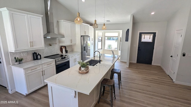 4442 E Aire Libre Ave, Phoenix, AZ 85032 - kitchen featuring stainless steel appliances, wall chimney range hood, a sink, decorative backsplash, and a kitchen breakfast bar