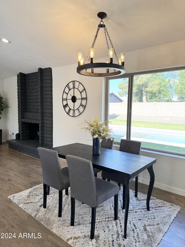 4442 E Aire Libre Ave, Phoenix, AZ 85032 - dining space with wood finished floors, baseboards, and a brick fireplace