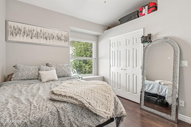 bedroom with a closet and dark wood-style flooring