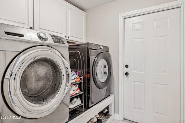 laundry room featuring washer and clothes dryer and cabinet space