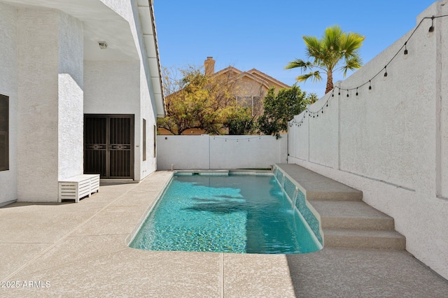 view of swimming pool featuring a fenced backyard and a patio