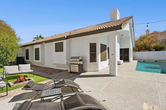 rear view of house featuring stucco siding, central AC unit, a patio area, fence, and a tiled roof