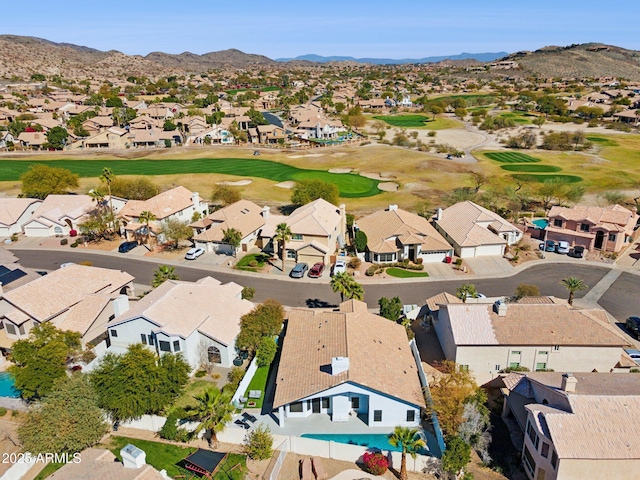 drone / aerial view with a residential view, view of golf course, and a mountain view