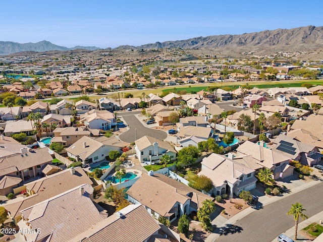 drone / aerial view featuring a residential view and a mountain view