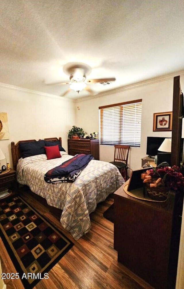 bedroom featuring crown molding, dark hardwood / wood-style floors, ceiling fan, and a textured ceiling