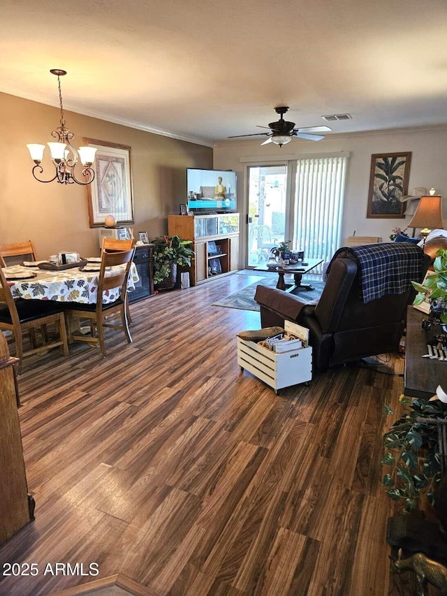 living room featuring ornamental molding, ceiling fan with notable chandelier, and hardwood / wood-style floors