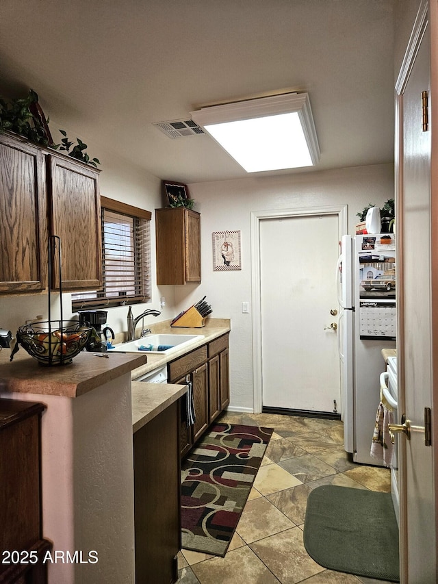 kitchen with sink and white refrigerator