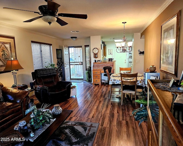 dining space with crown molding, dark wood-type flooring, and ceiling fan with notable chandelier